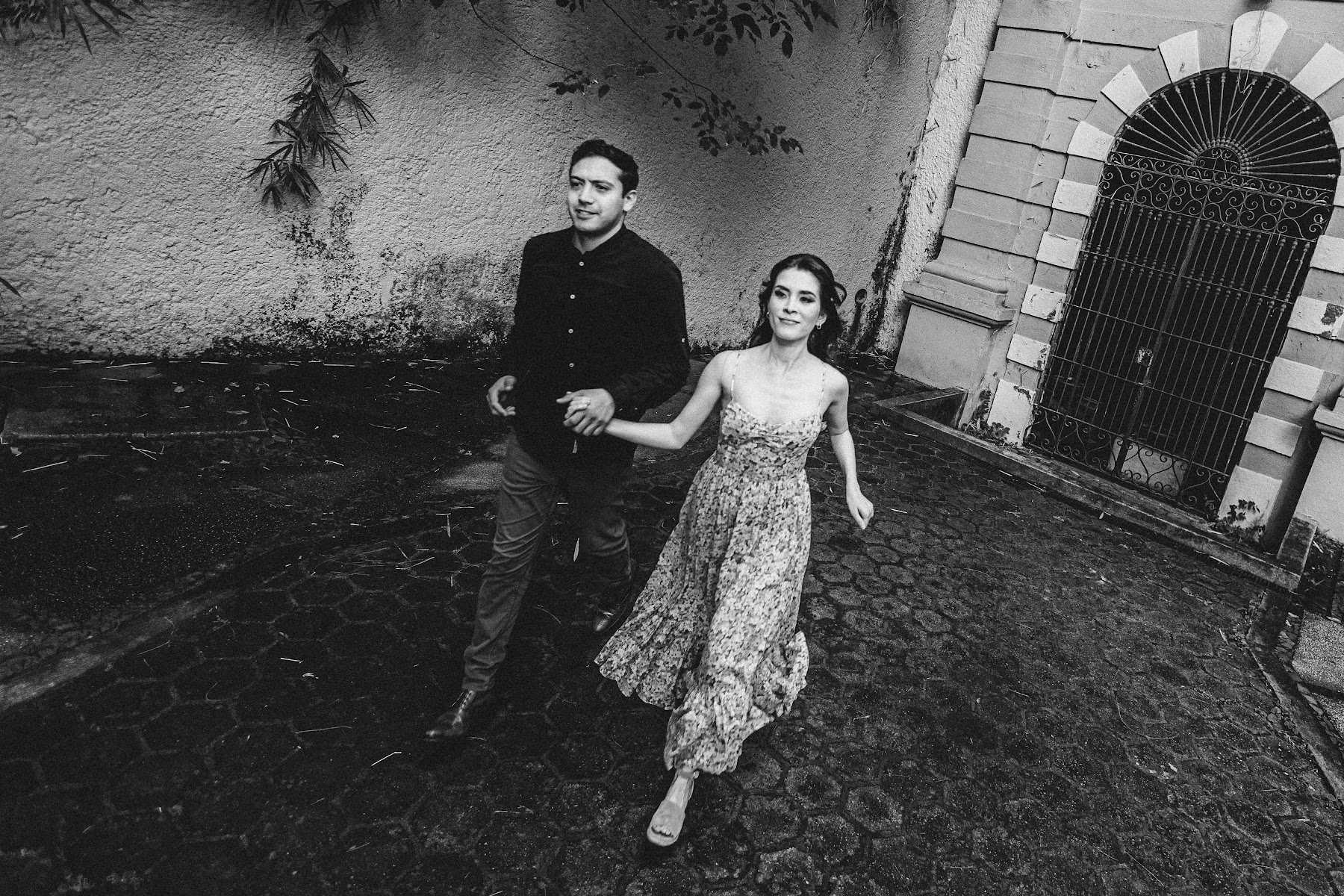 Arcelia y Adolfo caminan en una toma en blanco y negro.